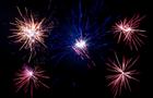 Five fireworks explode in the night sky