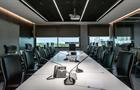 View of the Empty modern large group meeting room with video conference , office table and chairs