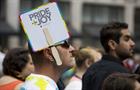 LGBTQ rights advocate with a sign that reads "Pride + Joy"