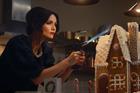 Sophie Ellis-Bextor using a blow torch on a gingerbread house