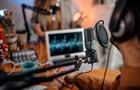 Image of aa person recording a podcast