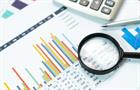Calculator with magnifying glass,Business concept with magnifying glass, calculator, pen, pencils and financial documents