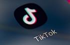 TikTok app icon on cell phone screen