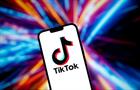 An image of the TikTok logo on a phone with a colourful background.