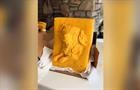 Block of cheese sculpted into a portrait of a dog