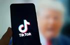 Image of Donald Trump behind the TikTok logo on a smartphone