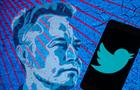 A blue and red artwork of Elon Musk's head next to a Blue Twitter logo in a black smartphone screen. (Getty Images) 