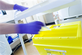 Nurse disposing of a used needle in a sharps bin  (Photo: SPL)