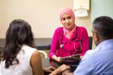 Female GP in discussion with patient and relative