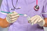 Nurse putting a cervical screening sample into a sample pot