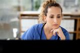 Woman doctor looking at a computer