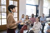 Woman lecturing to a group of students