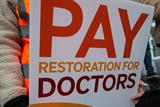 Pay restoration protest sign