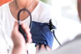 A patient having their blood pressure taken