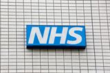 NHS logo on tiled wall