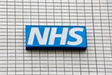 NHS logo on tiled wall