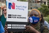 Nurse holds 'fair pay' placard