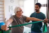 Physiotherapist works with patient