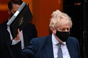 Boris Johnson holding a folder in the air