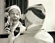 Haddon Sundblom holding a bottle of Coca-Cola