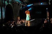 A model splashes on the catwalk in Vinopolis