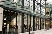 Next sales boosted by warmer weather