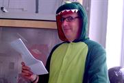 Kevin Chesters poses in his dinosaur suit
