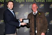 Duncan Miller presents the winner of the Event magazine stakes with his prize