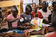 Girls enjoying Ni Nyampinga magazine, which reaches 100,000 girls across Rwanda