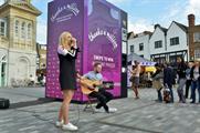 Lott performs for a suprised Nectar Card holder