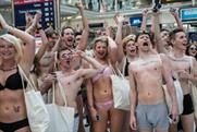 Naked protesters branded with TransferWise's campaign message