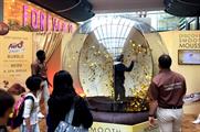 Shoppers are challenged to grab as many gold discs as they can within 30 seconds
