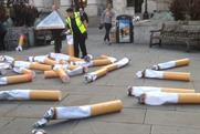 Giant cigarettes draw attention from crowds