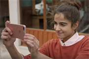 A vacationer becomes the village photographer in iPhone 7 spot