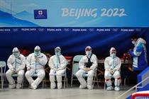 People in hazmat suits outside 'Beijing 2022' Winter Olympics venue