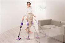 A woman using a Dyson Omniglide vacuum
