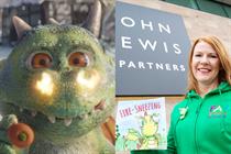 Edgar the dragon with flames around his nostrils and author Fay Evans holding her book 