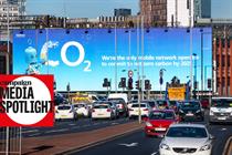 An O2 billboard next to a major road with the words 'We're the only mobile network operator to commit to net zero carbon by 2025'