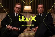 Two men in suits lounge on a sofa, looking at the camera. Text over the top reads: "ITVX. Launching 2022. A Spy Among Friends".