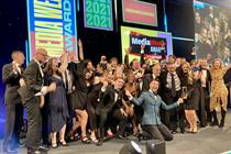 A group of staff from MG OMD gather onstage to collect their Agency of the Year award