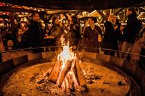 The fire pit at Hyde Park Winter Wonderland, surrounded by revellers