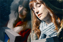 A still from Vodafone's 'Give the gift of connection' Christmas ad in which a woman's reflection transforms her into Santa