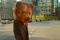 Person wearing a bear head walking through the streets of New York