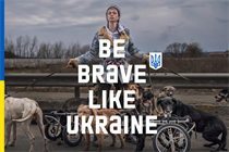 A Ukrainian woman stands after saving dogs from war 