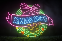 A still from the Park Christmas Savings Christmas campaign featuring a neon-lit Christmas bauble