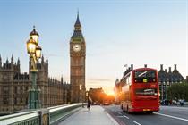 Photo of the Houses of Parliament from Westminster Bridge with a red number 12 bus driving over the bridge