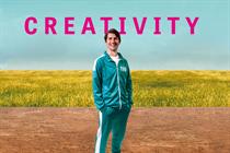 Stu Outhwaite-Noel dressed in a green and white Squid Game-style tracksuit against background of a green field and blue sky with the word 'Creativity' in pink just above his head