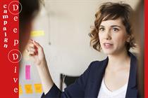 Image of woman presenting work to office colleagues