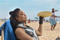 King Valkyrie relaxing on a beach and holding a frisbee