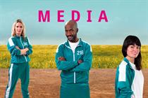 Pictured from left to right Ella Dolphin, Dino Myers-Lamptey and Natalie Cummins dressed in green and white Squid Game-style tracksuits against the background of a field and blue sky with the word Media in pink above them